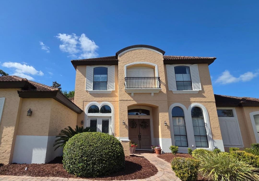 exterior painting project on two-story stucco home in Orlando Florida